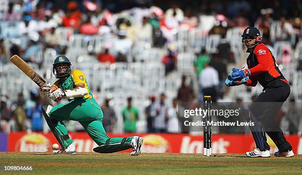 Hashim Amla of South Africa hits the ball towards the boundary, as Matt Prior of England looks on during the 2011 ICC World Cup match between England...