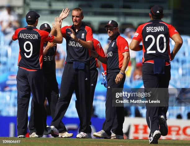 Stuart Broad of England is congratulated by Jimmy Anderson, after he bowled Hashim Amla of South Africa during the 2011 ICC World Cup match between...