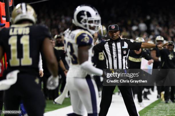 Referee watches as Tommylee Lewis of the New Orleans Saints drops a pass broken up by Nickell Robey-Coleman of the Los Angeles Rams during the fourth...