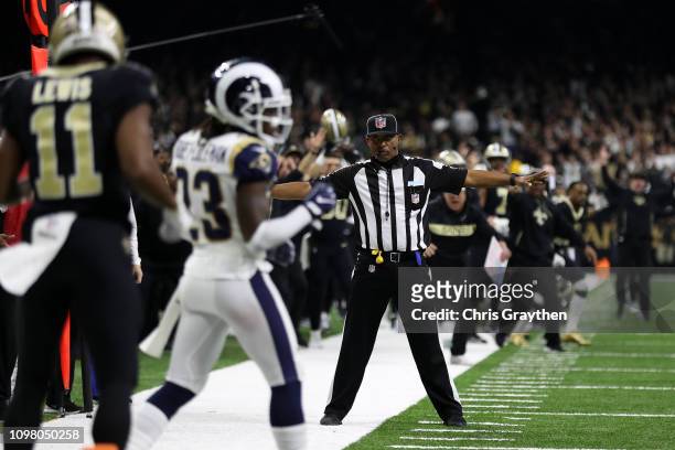 Referee watches as Tommylee Lewis of the New Orleans Saints drops a pass broken up by Nickell Robey-Coleman of the Los Angeles Rams during the fourth...