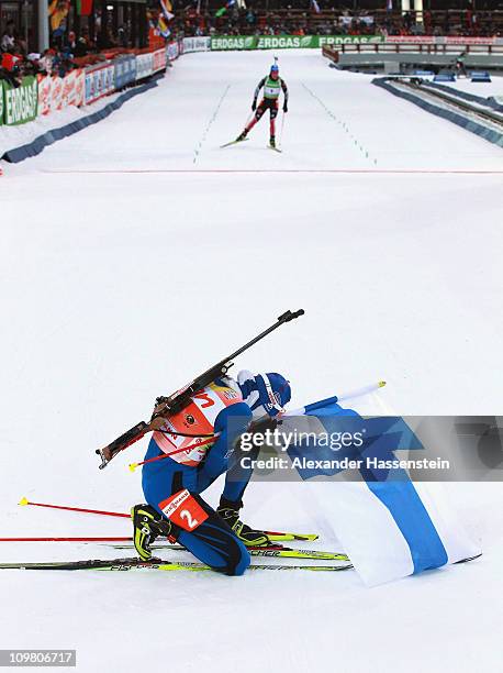 Kaisa Maekaeraeinen of Finland celebrates winning the gold medal whilst Magdalena Neuner of Germany finished the women's 10km pursuit during the IBU...