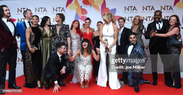 Claudia Winkleman, Tess Daly and Stacey Dooley and the cast of Strictly Come Dancing pose with the Talent Show Award in the winners room during the...