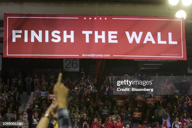 Banner reading "Finish the Wall" is displayed at a rally for U.S. President Donald Trump in El Paso, Texas, U.S., on Monday, Feb. 11, 2019. Trump and...