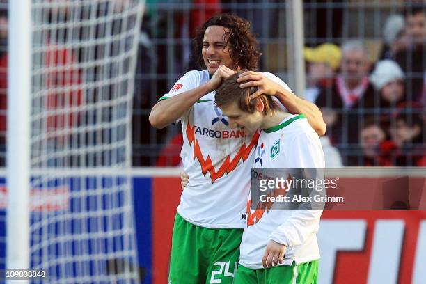 Claudio Pizarro of Bremen celebrates his team's second goal with team mate Marko Marin during the Bundesliga match between SC Freiburg and SV Werder...