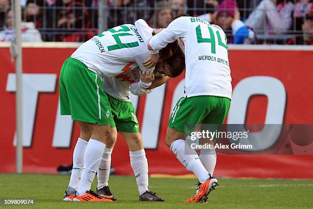 Claudio Pizarro of Bremen celebrates his team's second goal with team mates Marko Marin and Philipp Bargfrede during the Bundesliga match between SC...
