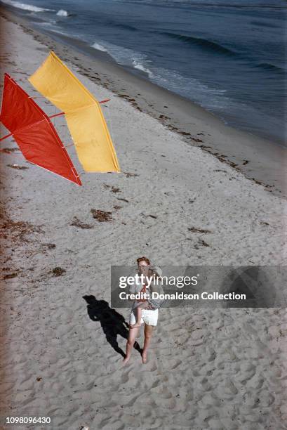 Actress June Lockhart flies a kite with her daughter Anne Maloney on June 19, 1957 in Los Angeles, California.