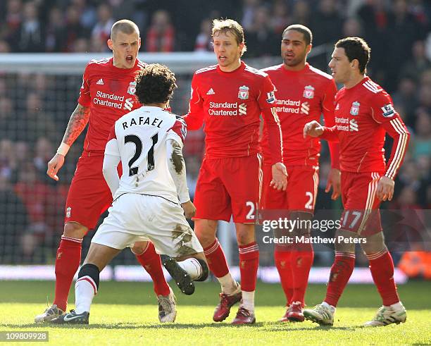 Rafael Da Silva of Manchester United clashes with Martin Skrtel, Lucas, Glen Johnson and Maxi Rodriguez of Liverpool during the Barclays Premier...