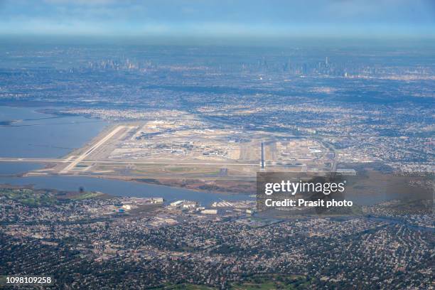 jfk airport from above with new york city in background in usa. - john f kennedy airport stock pictures, royalty-free photos & images