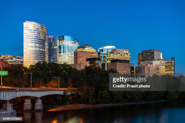 rosslyn skyline in twilight, washington dc, usa. a view n potomac river from georgetown park in us capital. - washington dc skyline night stock pictures, royalty-free photos & images