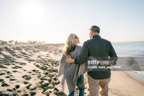 cost of retirment happiness - beach stock pictures, royalty-free photos & images
