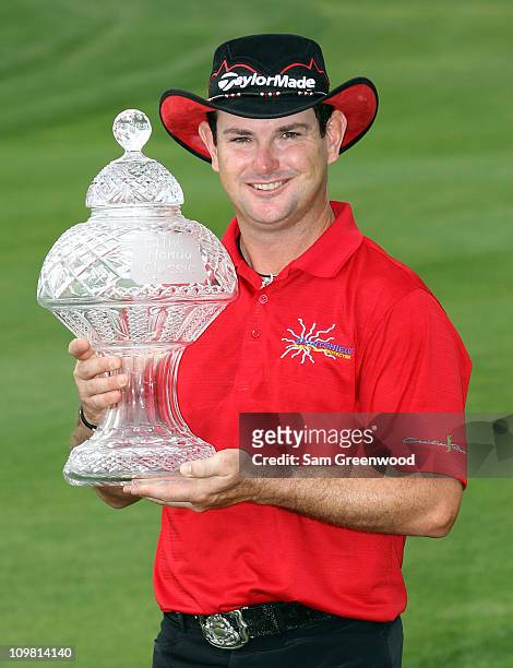 Rory Sabbatini of South Africa poses with the trophy after winning The Honda Classic at PGA National Resort and Spa on March 6, 2011 in Palm Beach...