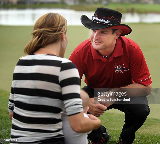 Rory Sabbatini talks briefly to his wife Amy during the Honda Classic in Palm Beach Gardens, Florida, on Sunday, March 6, 2011.