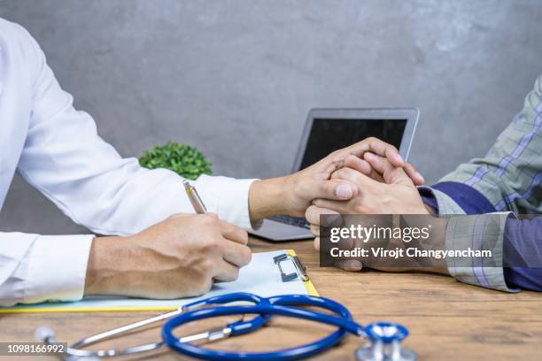 doctor hands holding patient hand and encouragement - kind doctor stock pictures, royalty-free photos & images