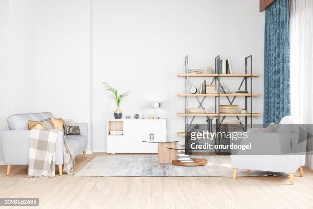 boekenkast, fauteuil en slaapbank in woonkamer - books on shelf stockfoto's en -beelden