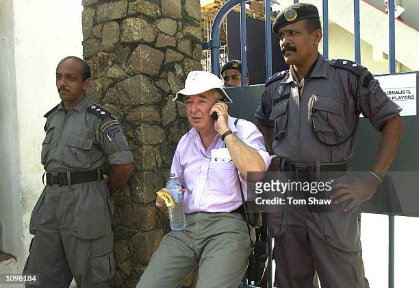 Peter Baxter the producer of the BBC radio cricket coverage is watched over by guards as he waits all day at the gates after the BBC were kept out of...