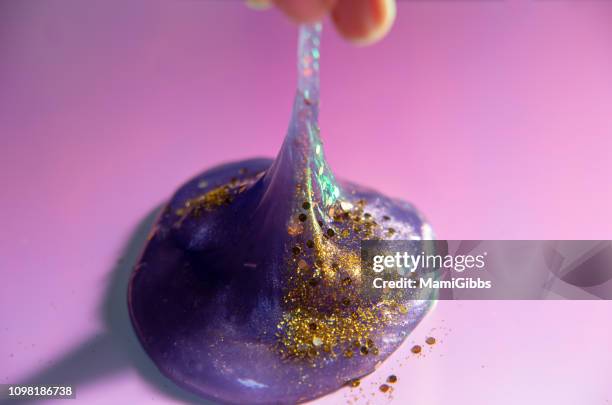 gold glitter on the slime - slimed stock pictures, royalty-free photos & images