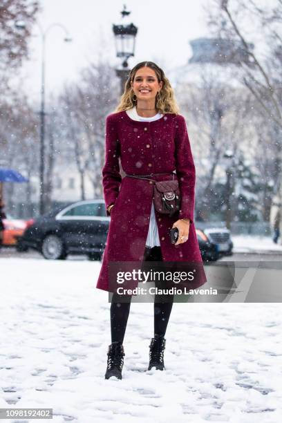 Helena Bordon, wearing a burgundy coat, white dress, black shoes and brown Chanel fanny pack, is seen outside Chanel show during Paris Fashion Week -...