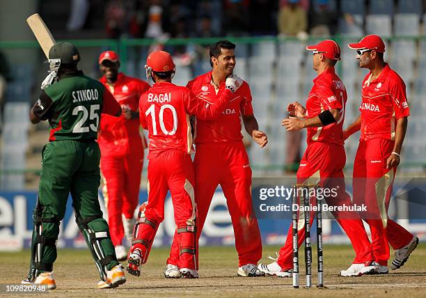 Rizwan Cheema of Canada celebrates with Ashish Bagai and team-mates after taking the wicket of Steve Tikolo of Kenya during the ICC Cricket World Cup...