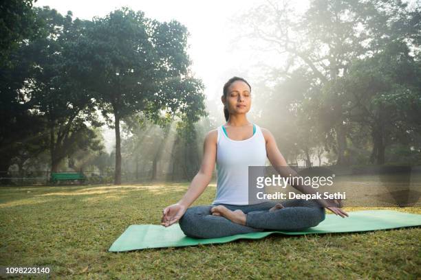 meditation in the park - stock image - yoga teen stock pictures, royalty-free photos & images