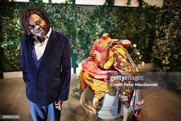 Artist Yinka Shonibare's stands in his maze installation entitled 'Jardin d'amour' at the Parasol unit for contemporary art on March 7, 2011 in...