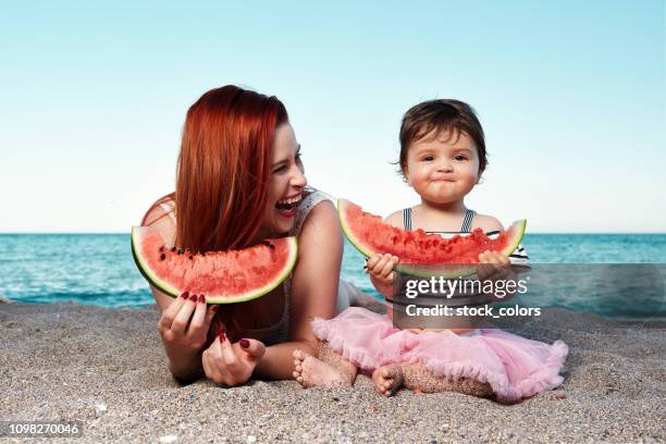 eating delicious watermelon - romania beach stock pictures, royalty-free photos & images