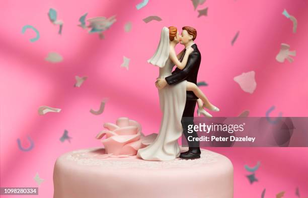 newly married couple embracing - wedding cake stock-fotos und bilder