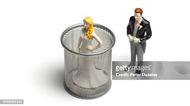 controlling groom putting bride in garbage bin - couple trapped stock pictures, royalty-free photos & images