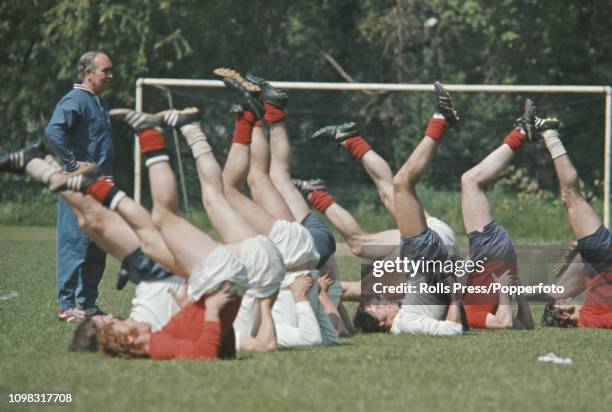 Manager of the England national team Alf Ramsey watches his squad during a training session with members of the national team at Roehampton in south...