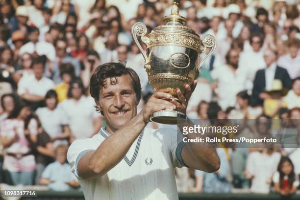 Czech tennis player Jan Kodes raises the Gentlemen's Singles Trophy after defeating Alex Metreveli of the Soviet Union to win the final of the Men's...