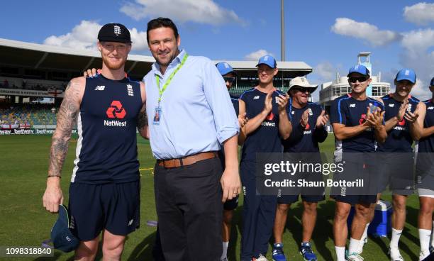 Ben Stokes of England is presented with his 50th test cap by former England fast bowler Steve Harmison during Day One of the First Test match between...