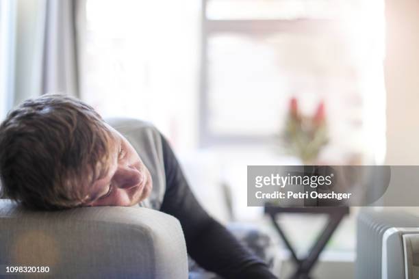 an adult male sick at home. - weakness man stock pictures, royalty-free photos & images