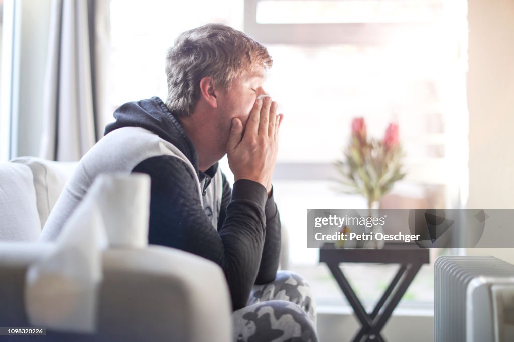 An Adult male sick at home.