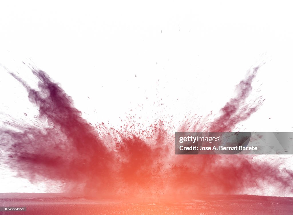 Explosion by an impact of a cloud of particles of powder of color purple on a white background.