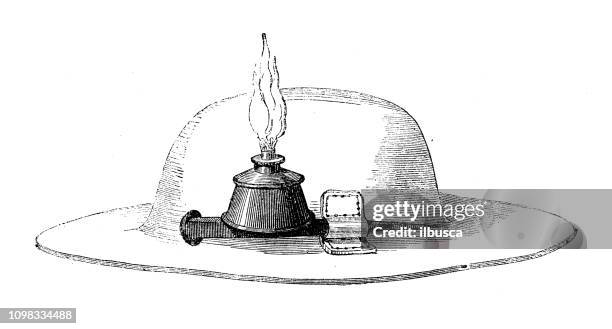 antique illustration engraving of manufacturing industry: miner hat lantern - mining hats stock illustrations