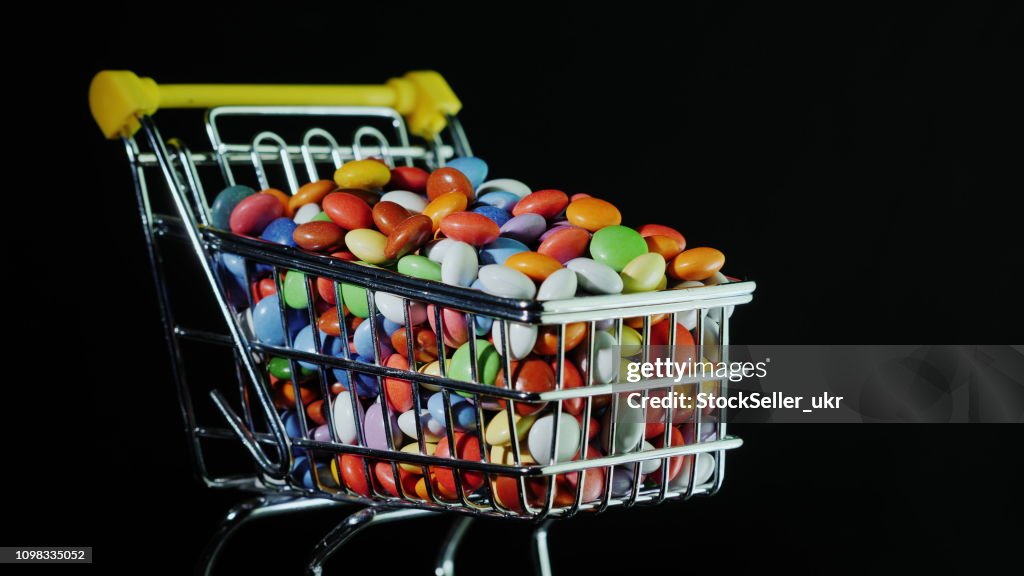 Small shopping cart with multi-colored candies