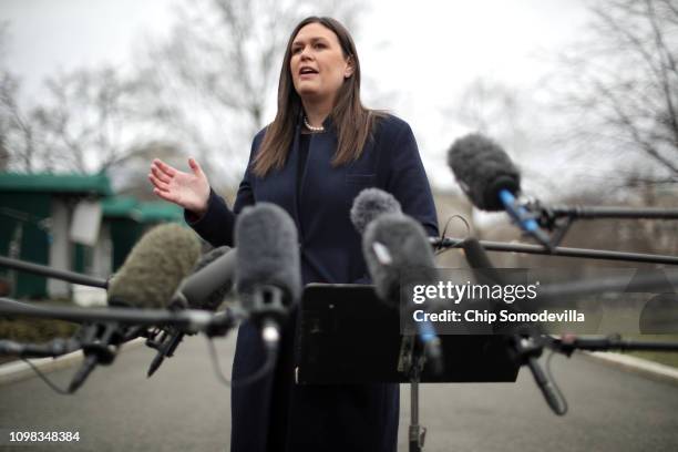 White House Press Secretary Sarah Huckabee Sanders talks to reporters following a television interview with FOX News outside the White House January...