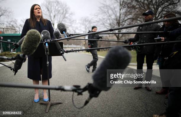 White House Press Secretary Sarah Huckabee Sanders talks to reporters following a television interview with FOX News outside the White House January...