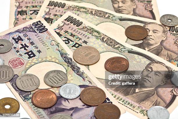 close up image of japanese yen on a white background - japanese yen note stockfoto's en -beelden
