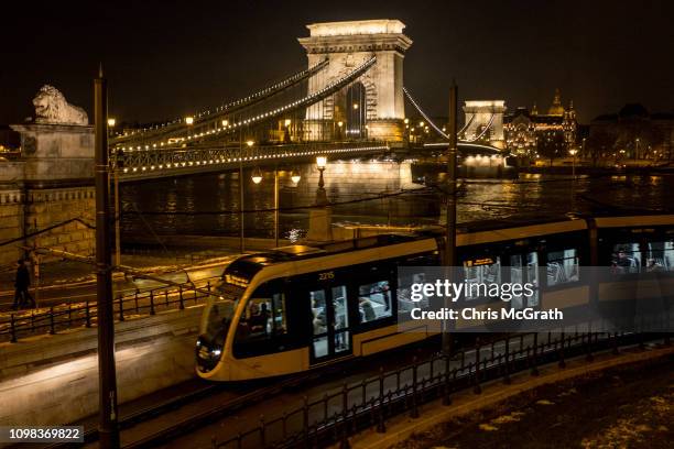 Tram passes in front of the Szechenyi Chain Bridge on January 20, 2019 in Budapest, Hungary. Over the past months thousands of Hungarians have turned...