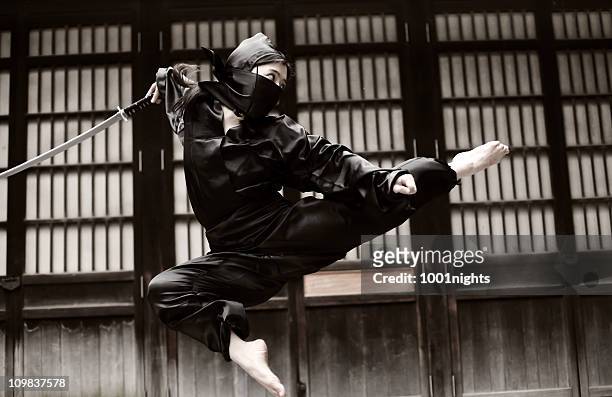 asian woman showing her ninja moves - japanese martial arts stock pictures, royalty-free photos & images
