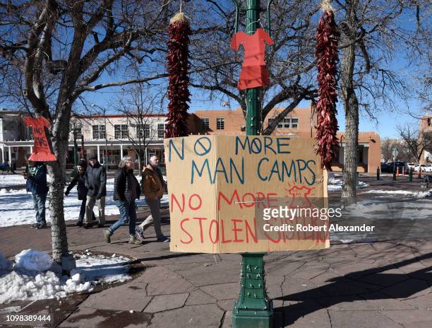 Sign made by Native American activists hangs in the Plaza in Santa Fe, New Mexico, during the 2019 Women's March. The sign refers to missing Native...