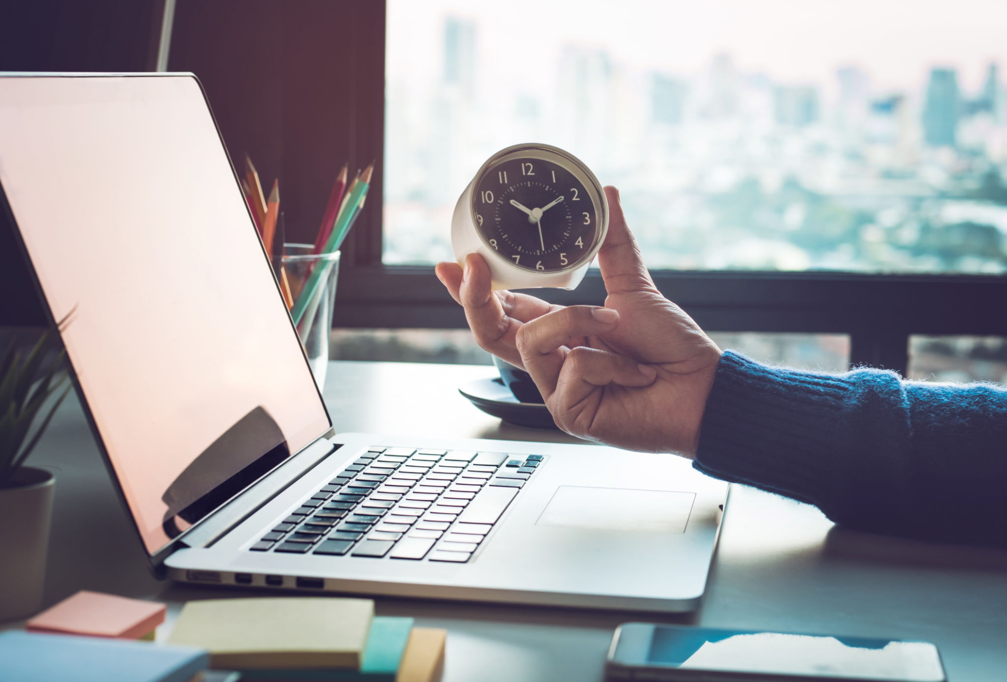 Business concepts with businessman holding clock on computer laptop.For investment analysis,Waiting to sucess Business concepts with businessman holding clock on computer laptop.For investment analysis,Waiting to sucess