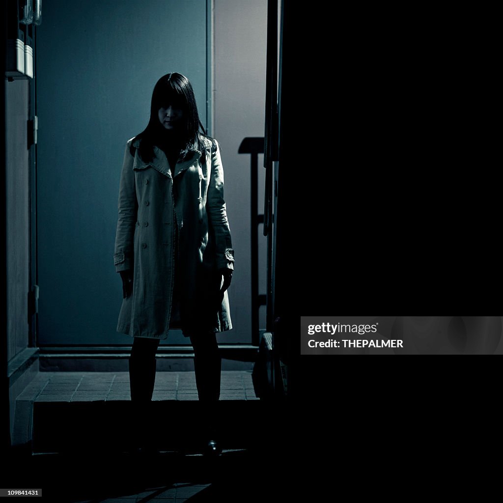 Spooky japanese girl at the entrance of building