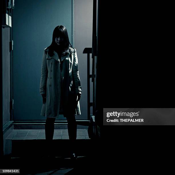 spooky japanese girl at the entrance of building - mystery crime stock pictures, royalty-free photos & images