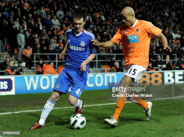 Josh McEachran of Chelsea competes with Alex Baptiste of Blackpool during the Barclays Premier League match between Blackpool and Chelsea at...