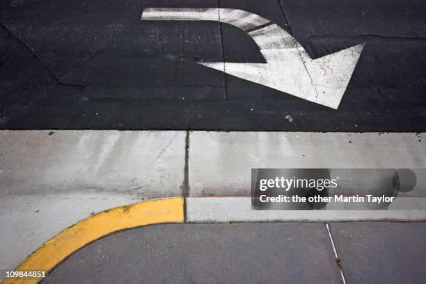 direction arrow & curb - kerb stock pictures, royalty-free photos & images