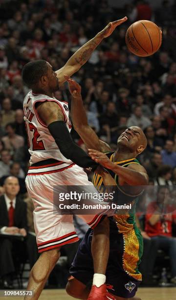 Watson of the Chicago Bulls blocks a shot by Jarrett Jack of the New Orleans Hornets but is called for a foul at the United Center on March 7, 2011...