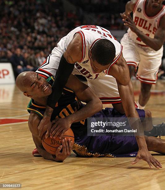 Watson of the Chicago Bulls tries to grab the ball from Jarrett Jack of the New Orleans Hornets and forces a jump ball at the United Center on March...