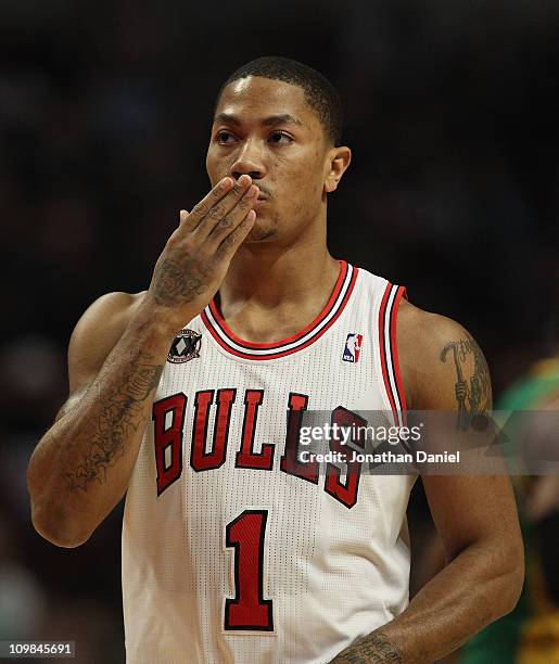 Derrick Rose of the Chicago Bulls blows a kiss to members of his family in the stands before the tip-off of a game against the New Orleans Hornets at...