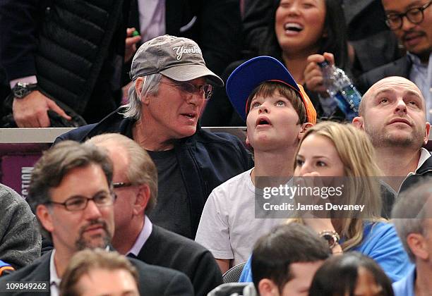 Richard Gere and son Homer James Jigme Gere attend the Utah Jazz vs New York Knicks game at Madison Square Garden on March 7, 2011 in New York City.